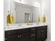 Bathroom featuring a double vanity with modern fixtures, ample counter space, and neutral decor with bright yellow towels at 184 Wildfell Trl, Cary, NC 27513