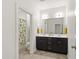 Bathroom showcasing a dual sink vanity, modern fixtures, and a neutral color palette with stylish geometric patterned shower curtain at 184 Wildfell Trl, Cary, NC 27513