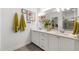 Bright bathroom with double sinks, ample counter space, and an oversized vanity mirror at 184 Wildfell Trl, Cary, NC 27513