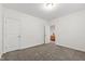 Bedroom with neutral carpet and view into an adjacent room with wood furniture at 184 Wildfell Trl, Cary, NC 27513