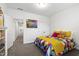 Comfortable room featuring colorful bedding, a side-table and a view of the hallway at 184 Wildfell Trl, Cary, NC 27513