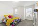 Comfortable room featuring colorful bedding, a side-table and natural lighting at 184 Wildfell Trl, Cary, NC 27513