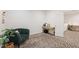 Comfortable bedroom featuring a chair near the window, a modern desk and modern geometric-patterned carpet at 184 Wildfell Trl, Cary, NC 27513