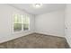 Bright bedroom with a large window offering natural light and a neutral carpet at 184 Wildfell Trl, Cary, NC 27513