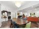 Open-concept dining area featuring a wood table and comfortable seating, seamlessly connecting to the living room at 184 Wildfell Trl, Cary, NC 27513