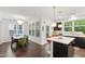 Bright dining area with large windows, a modern chandelier, and an elegant wooden table at 184 Wildfell Trl, Cary, NC 27513