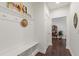 Bright entryway with mudroom features, hat rack, and dark wood flooring at 184 Wildfell Trl, Cary, NC 27513