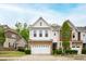 Charming two-story townhome featuring a stone-accented garage and manicured front lawn at 184 Wildfell Trl, Cary, NC 27513