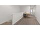 Upstairs hallway with desk area and neutral carpet throughout at 184 Wildfell Trl, Cary, NC 27513