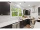 Beautiful kitchen countertop with tile backsplash and stainless steel appliances under a bright window at 184 Wildfell Trl, Cary, NC 27513