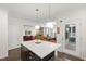 Bright kitchen features a large island with pendant lighting and white countertops, connecting to the living space at 184 Wildfell Trl, Cary, NC 27513