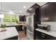 Well-equipped kitchen featuring stainless steel appliances, dark cabinets, and a modern microwave at 184 Wildfell Trl, Cary, NC 27513