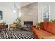 Modern living room with a fireplace, hardwood floors, and contemporary furniture at 184 Wildfell Trl, Cary, NC 27513