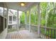 Relaxing screened porch with ceiling fan and wooden floors offers an inviting outdoor living space at 184 Wildfell Trl, Cary, NC 27513