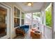 Relaxing screened-in porch featuring a comfortable seating area, bright lighting, and exterior views at 184 Wildfell Trl, Cary, NC 27513
