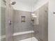 Modern shower with gray tiling and built-in shelving, illuminated by recessed lighting at 184 Wildfell Trl, Cary, NC 27513