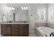 This bathroom has a double sink vanity with granite countertop and a soaking tub with shutters at 200 Windy Knoll Cir, Chapel Hill, NC 27516