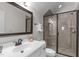 A full bathroom with single vanity, large mirror, and a walk-in shower with glass door at 200 Windy Knoll Cir, Chapel Hill, NC 27516