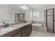 Elegant bathroom featuring granite countertops, double sinks, soaking tub, and walk-in shower at 200 Windy Knoll Cir, Chapel Hill, NC 27516