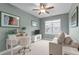 Cozy bedroom featuring a ceiling fan, a sofa, a desk, and a window with a view at 200 Windy Knoll Cir, Chapel Hill, NC 27516