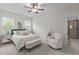 Bright bedroom featuring a ceiling fan, a comfy chair, and a well-lit sitting area at 200 Windy Knoll Cir, Chapel Hill, NC 27516