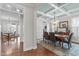 Formal dining room featuring coffered ceilings, a chandelier, hardwood floors, and seating for six at 200 Windy Knoll Cir, Chapel Hill, NC 27516