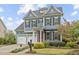 Charming two-story home boasts a red door, three-car garage, and professionally landscaped front yard at 200 Windy Knoll Cir, Chapel Hill, NC 27516