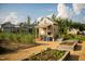 Charming garden area with raised planting beds and a potting shed at 200 Windy Knoll Cir, Chapel Hill, NC 27516