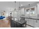 Open-concept kitchen and living area with dark island, granite counters, and hardwood floors at 200 Windy Knoll Cir, Chapel Hill, NC 27516