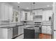 Modern kitchen with white cabinets, stainless steel appliances, and a central island at 200 Windy Knoll Cir, Chapel Hill, NC 27516