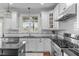 Bright kitchen showcasing white cabinets, subway tile backsplash, and modern stainless steel appliances at 200 Windy Knoll Cir, Chapel Hill, NC 27516