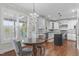 Bright kitchen and dining area with white cabinets, stainless appliances, and island at 200 Windy Knoll Cir, Chapel Hill, NC 27516