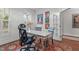 The office features a white desk, unique chairs, large windows and views of the exterior at 200 Windy Knoll Cir, Chapel Hill, NC 27516