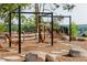 Community playground area featuring swings, a hammock, and natural stone landscaping at 200 Windy Knoll Cir, Chapel Hill, NC 27516