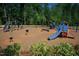 A colorful playground with slides and climbing structure sits amid lush green trees at 200 Windy Knoll Cir, Chapel Hill, NC 27516