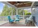 Screened porch with ceiling fan and an assortment of blue chairs and seating at 200 Windy Knoll Cir, Chapel Hill, NC 27516