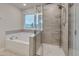 Bathroom featuring a soaking tub and tiled shower with a glass enclosure at 205 Loxton St, Fuquay Varina, NC 27526