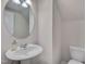 Clean and simple bathroom features a modern pedestal sink and toilet with neutral decor at 205 Loxton St, Fuquay Varina, NC 27526