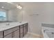 Bathroom with a double sink vanity, tile floor, and large mirror at 205 Loxton St, Fuquay Varina, NC 27526