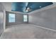 Spacious bedroom with a tray ceiling, carpet, two windows, and neutral-colored walls at 205 Loxton St, Fuquay Varina, NC 27526