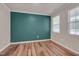 Bright bedroom with hardwood floors, neutral walls, and abundant natural light from two windows at 205 Loxton St, Fuquay Varina, NC 27526