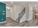 Inviting entryway with a staircase, open to a spacious living area and a modern kitchen at 205 Loxton St, Fuquay Varina, NC 27526