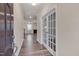 Inviting entryway with hardwood floors and view into the living area featuring stylish french doors at 205 Loxton St, Fuquay Varina, NC 27526