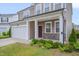 Inviting home exterior featuring a covered front porch with stone accents and a well-maintained lawn at 205 Loxton St, Fuquay Varina, NC 27526