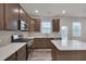 Updated kitchen boasts stainless steel appliances, a center island, and modern countertops at 205 Loxton St, Fuquay Varina, NC 27526