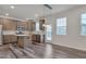 Modern kitchen with stainless steel appliances, granite countertops, and an island, flowing into the living area at 205 Loxton St, Fuquay Varina, NC 27526