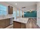 Beautiful kitchen with stainless appliances, central island, ample counter space, and seamless access to the living area at 205 Loxton St, Fuquay Varina, NC 27526