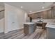 Modern kitchen with stainless steel appliances, an island, and ample cabinet space, conveniently located near the staircase at 205 Loxton St, Fuquay Varina, NC 27526