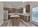 Stylish kitchen with stainless steel appliances, granite counters, central island, and ample cabinet space at 205 Loxton St, Fuquay Varina, NC 27526