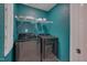 Convenient laundry room with modern front-load washer and dryer, plus storage shelving at 205 Loxton St, Fuquay Varina, NC 27526